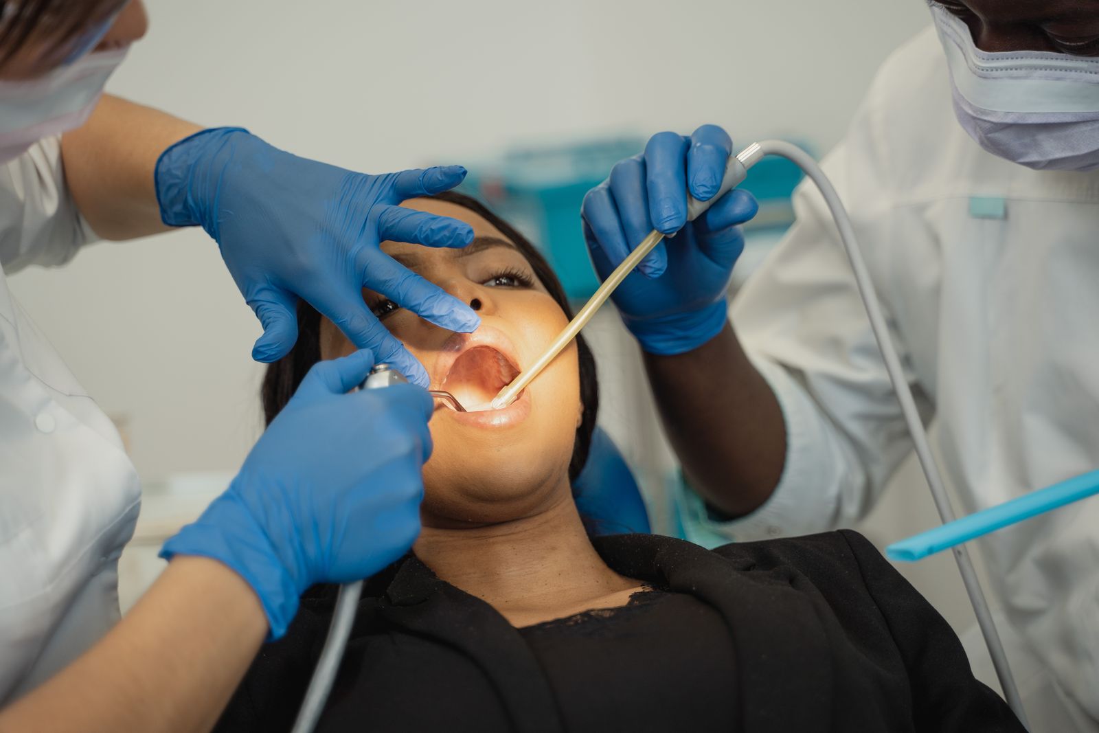 Dental professionals examining a patient in a dental clinic.
